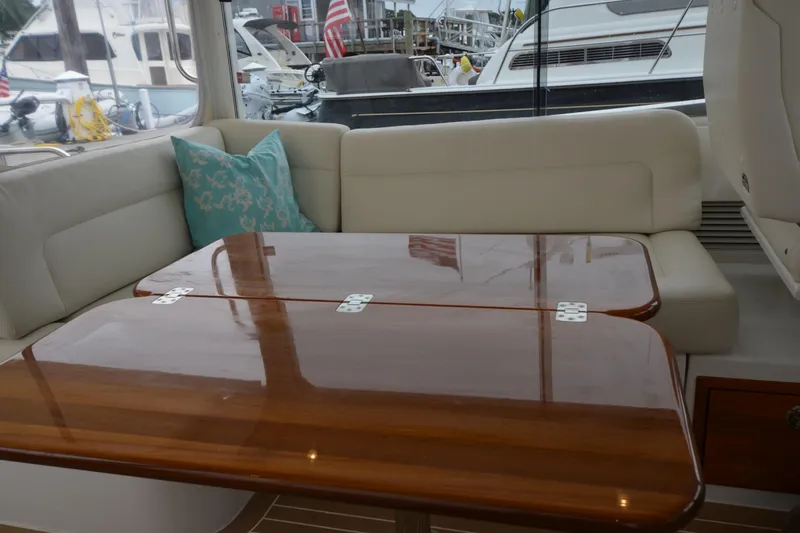 Slide: The Image of Luxurious interior of 2020 MJM 43z yacht with polished wooden table and cushioned seating. - 23