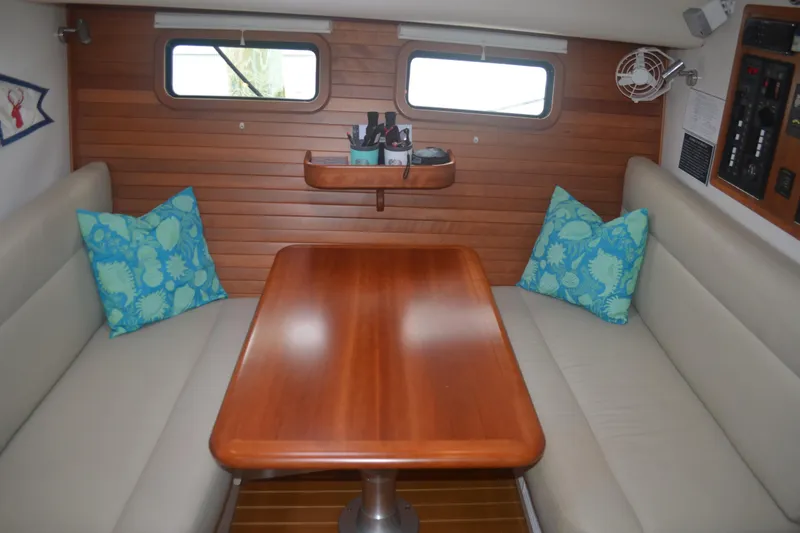 Slide: The Image of Interior of 2020 MJM 43z yacht with wooden table and blue cushions. - 29