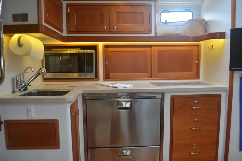 Slide: The Image of Modern kitchen in 2020 MJM 43z yacht with wood cabinets and stainless steel appliances. - 30