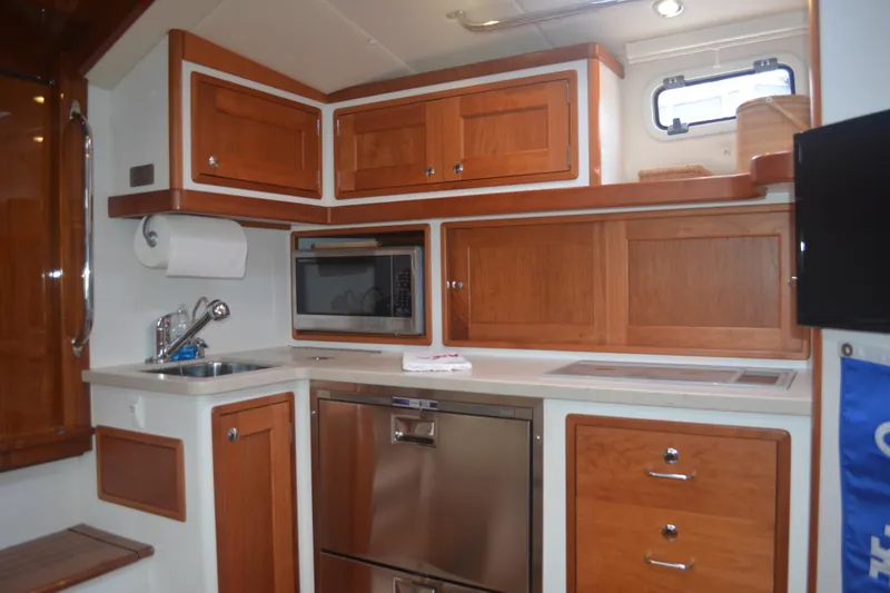 Slide: The Image of Modern galley kitchen in 2020 MJM 43z yacht with wood cabinetry and stainless appliances. - 31