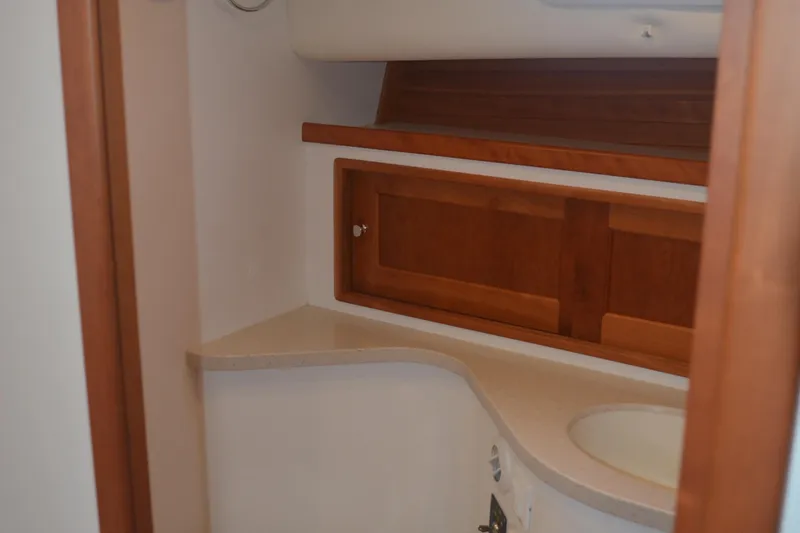 Slide: The Image of Interior of 2020 MJM 43z yacht featuring wooden cabinetry and a compact sink area. - 36