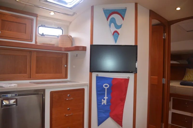 Slide: The Image of Interior of 2020 MJM 43z yacht with wood cabinetry and mounted TV. - 39