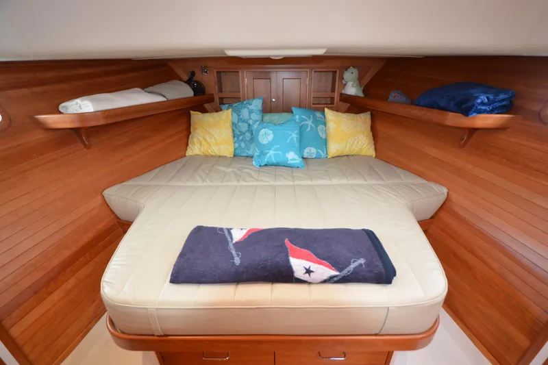 Slide: The Image of Cozy cabin interior of 2020 MJM 43z yacht with plush bedding and wooden accents. - 40