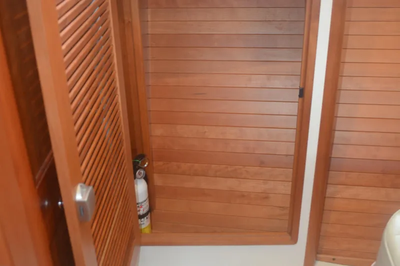 Slide: The Image of Wooden interior of 2020 MJM 43z boat with fire extinguisher storage. - 43