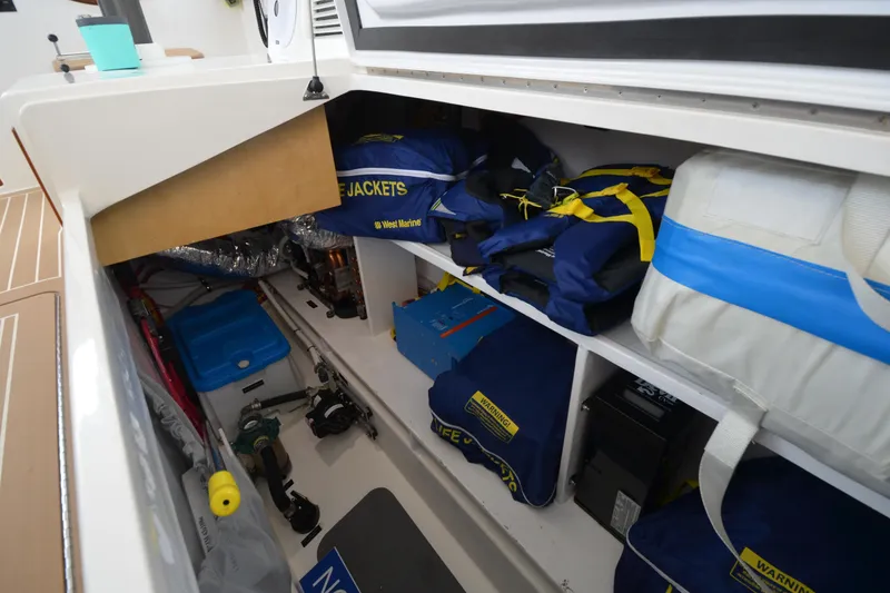 Slide: The Image of Storage compartment of 2020 MJM 43z boat with life jackets and equipment. - 45