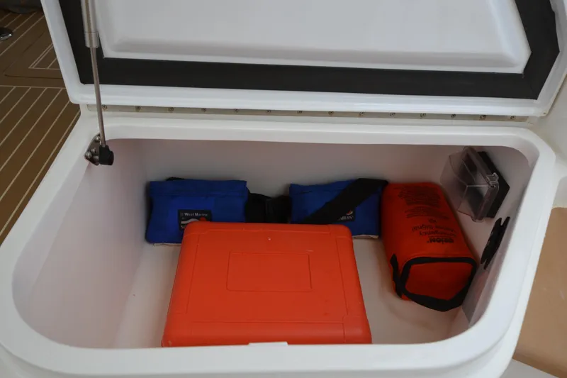 Slide: The Image of Open storage compartment on 2020 MJM 43z boat with safety equipment inside. - 46