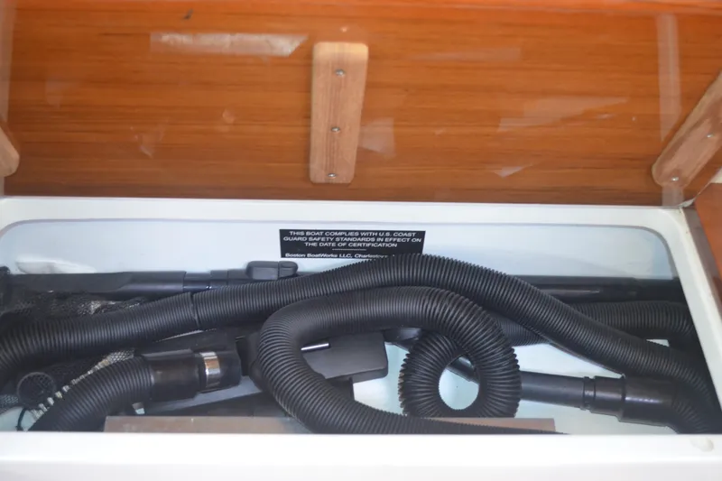 Slide: The Image of Storage compartment with hoses in 2020 MJM 43z boat interior. - 59