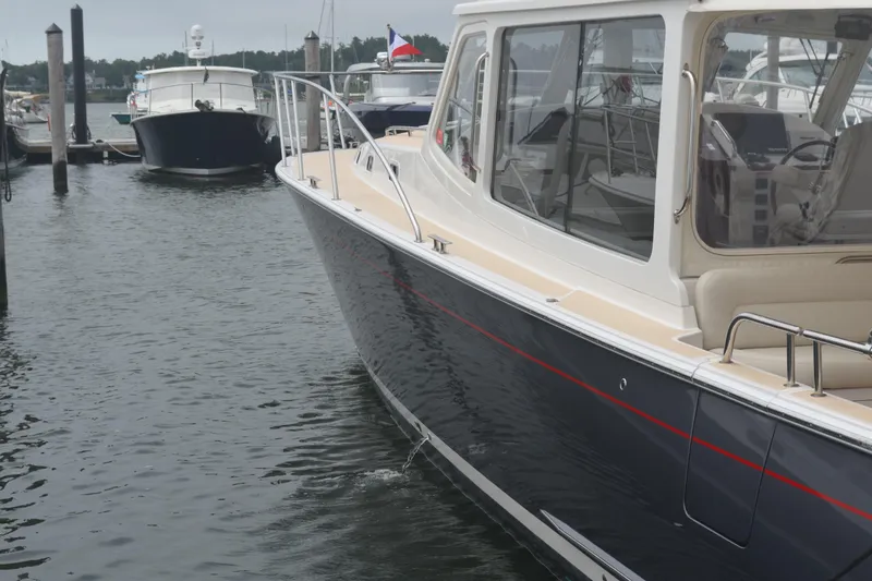 Slide: The Image of 2020 MJM 43z yacht docked in marina, sleek design, calm waters. - 7