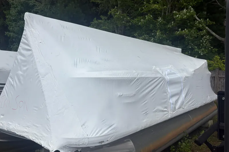 Slide: The Image of 2017 Sun Tracker Party Barge 20 DLX covered in white tarp, outdoors. - 12