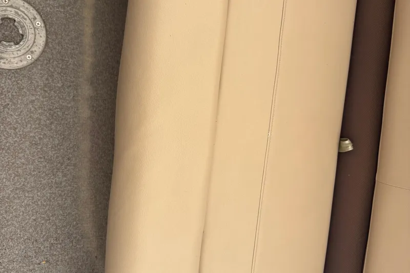 Slide: The Image of 2017 Sun Tracker Party Barge 20 DLX interior with beige seating and gray flooring. - 5