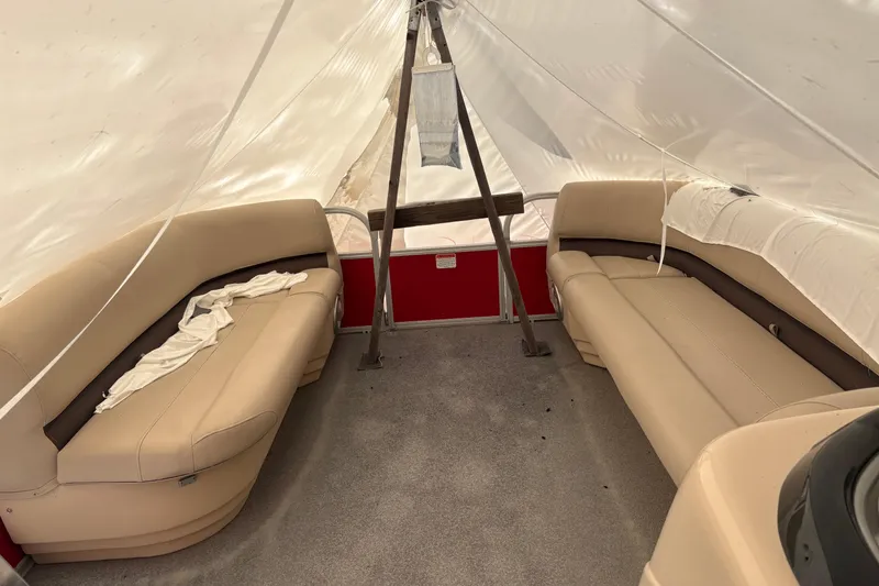 Slide: The Image of Interior of a 2017 Sun Tracker Party Barge 20 DLX with beige seating. - 6