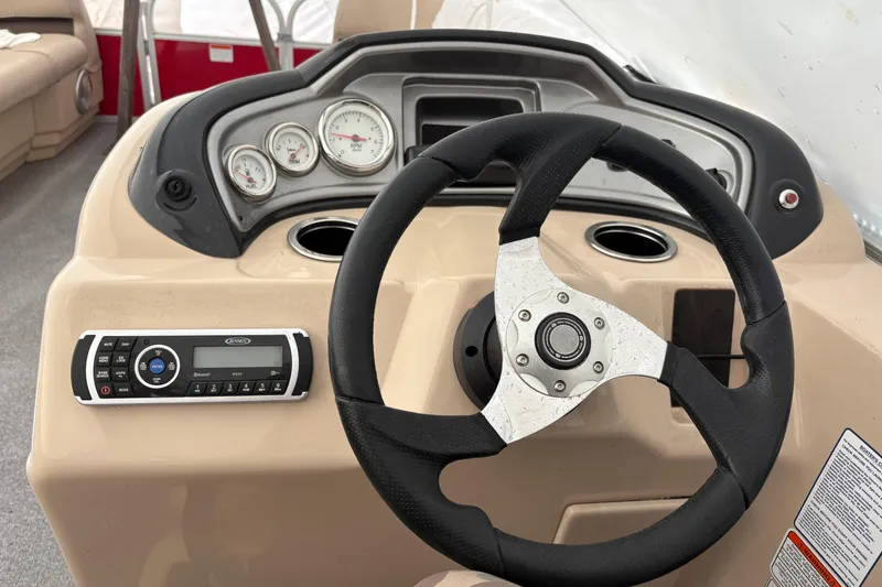Slide: The Image of Steering console of a 2017 Sun Tracker Party Barge 20 DLX with gauges and controls. - 9