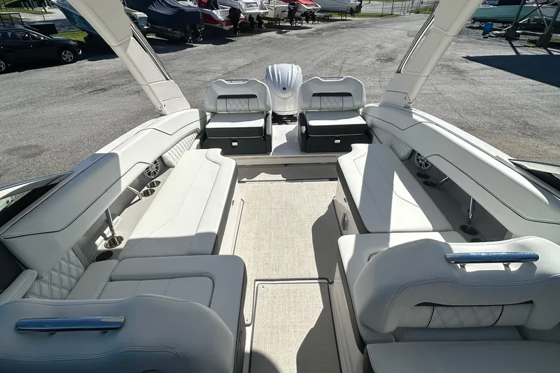 Slide: The Image of 2023 Regal LX6 boat interior with luxurious white seating and spacious layout. - 10