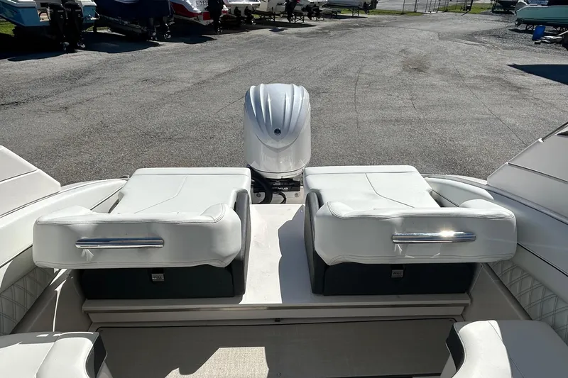 Slide: The Image of 2023 Regal LX6 boat interior with white seating and outboard motor. - 12