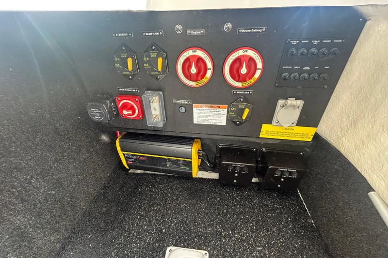 Slide: The Image of 2023 Regal LX6 boat control panel with switches and battery management system. - 17