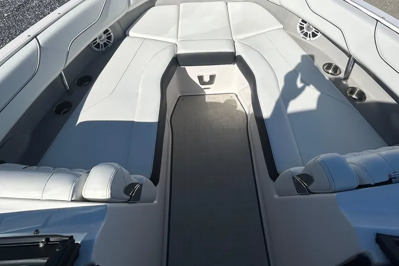 Slide: The Image of 2023 Regal LX6 boat interior with white seating and cup holders. - 5