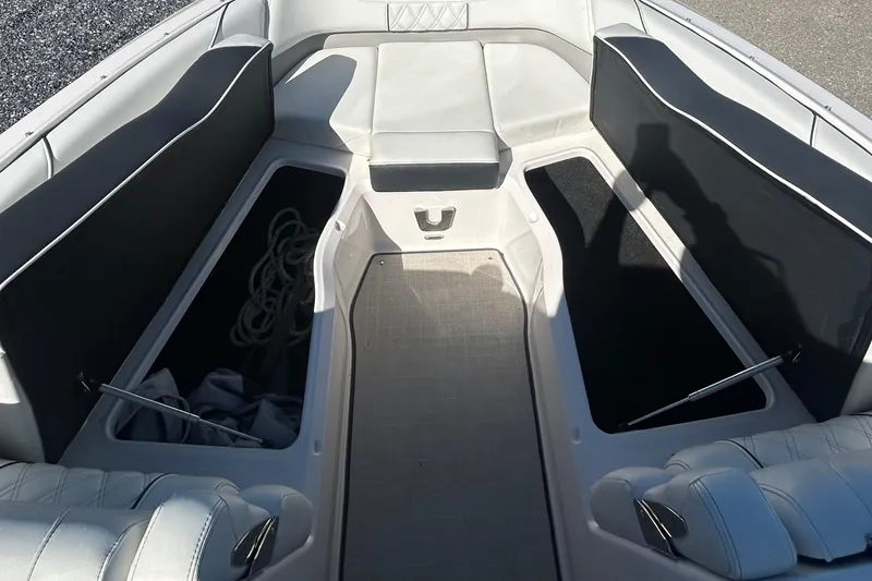 Slide: The Image of 2023 Regal LX6 boat interior with open storage compartments and seating. - 6