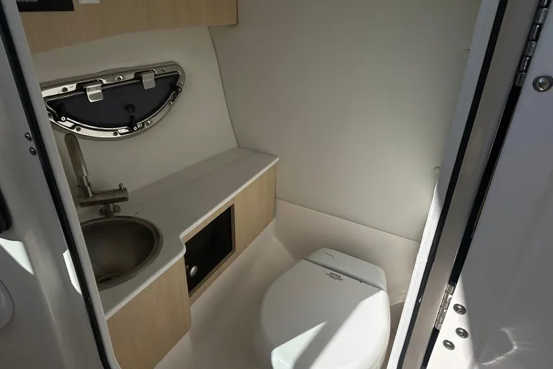 Slide: The Image of 2023 Regal LX6 boat interior bathroom with sink and toilet. - 7