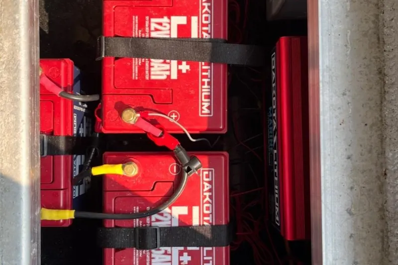 Slide: The Image of Lithium batteries in Ocean King 220 boat, 2023 model, with red and black wiring. - 10