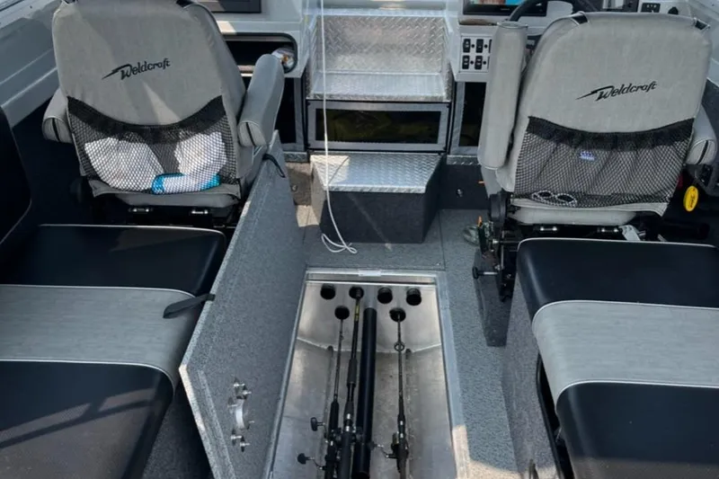 Slide: The Image of 2023 Ocean King 220 boat interior with seating and fishing rod storage. - 11
