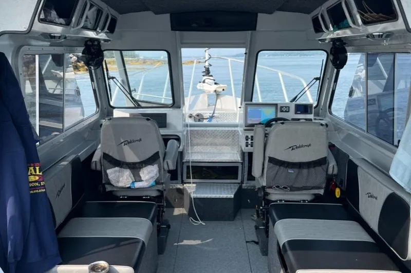 Slide: The Image of Interior of 2023 Ocean King 220 boat with modern navigation equipment and seating. - 12