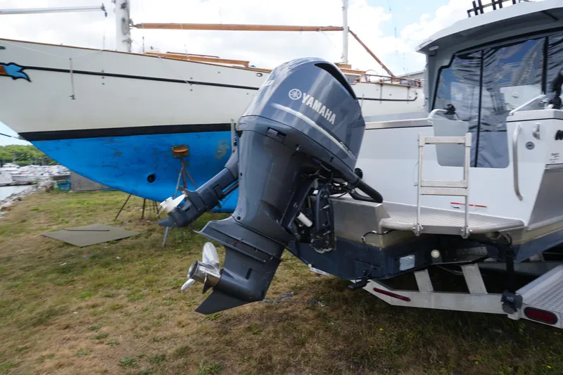 Slide: The Image of 2023 Weldcraft Ocean King 220 with Yamaha outboard motor, docked on grass. - 24