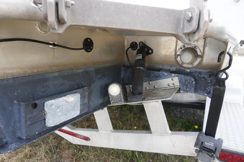 Slide: The Image of 2023 Weldcraft Ocean King 220 boat underside showing trim tab and hydraulic components. - 26