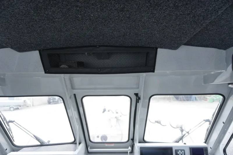 Slide: The Image of Interior view of 2023 Weldcraft Ocean King 220 boat cabin with windows and ceiling details. - 34