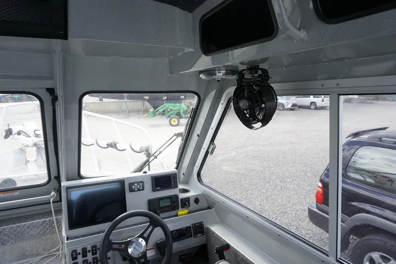 Slide: The Image of Interior view of 2023 Weldcraft Ocean King 220 boat cockpit with steering wheel and controls. - 35