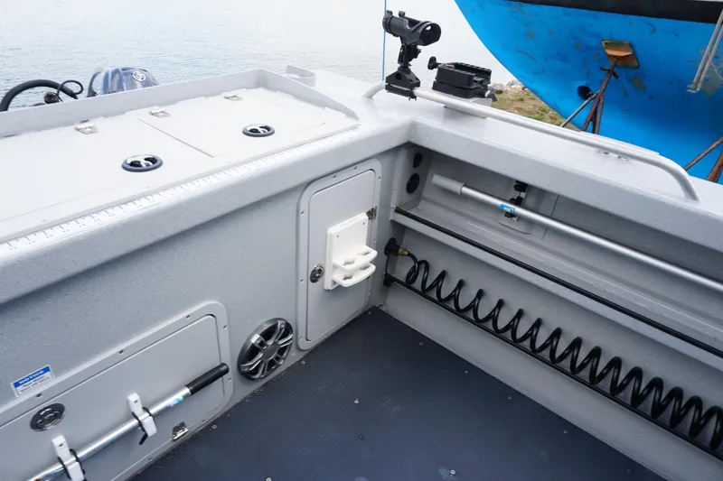 Slide: The Image of 2023 Weldcraft Ocean King 220 boat interior with storage compartments and fishing rod holders. - 48