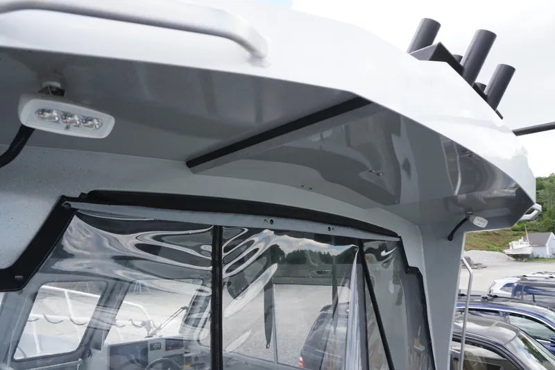 Slide: The Image of 2023 Weldcraft Ocean King 220 boat cabin exterior with sleek design and clear windows. - 52