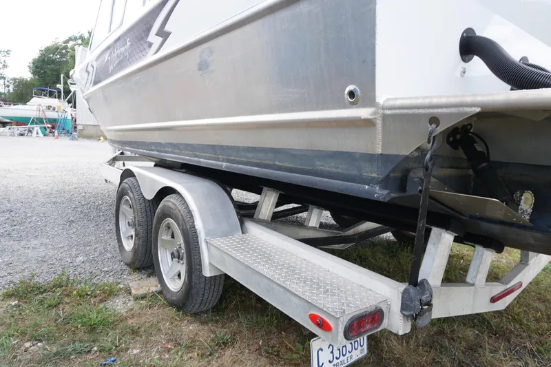 Slide: The Image of 2023 Weldcraft Ocean King 220 boat on trailer, side view, parked on gravel. - 61