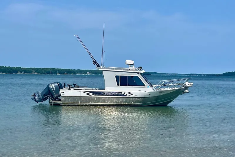 Slide: The Image of 2023 Weldcraft Ocean King 220 boat anchored in calm waters. - 0