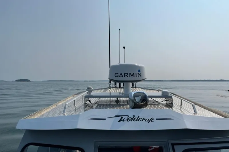 Slide: The Image of 2023 Ocean King 220 boat with Garmin radar on calm waters. - 13