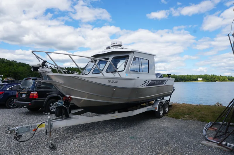Slide: The Image of 2023 Weldcraft Ocean King 220 boat on trailer by a lake under a blue sky. - 16