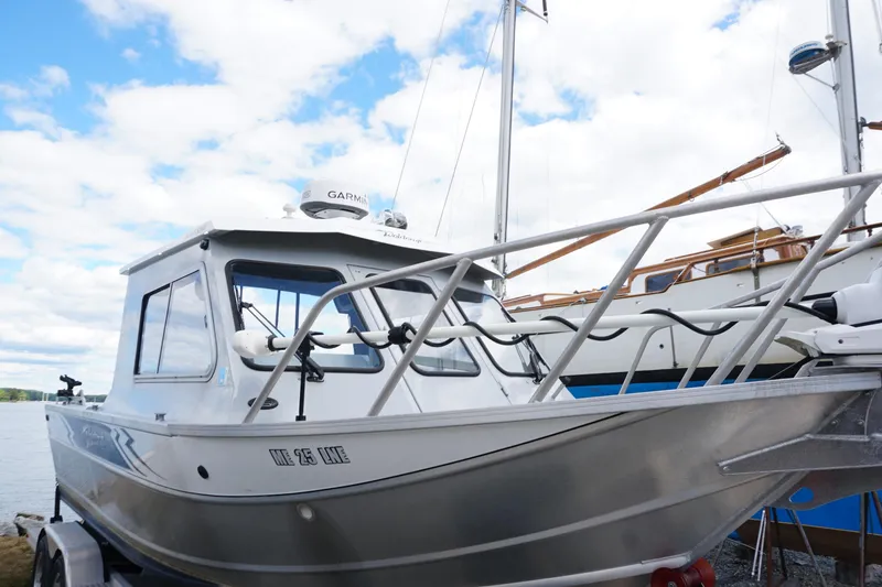 Slide: The Image of 2023 Weldcraft Ocean King 220 boat docked under a partly cloudy sky. - 20