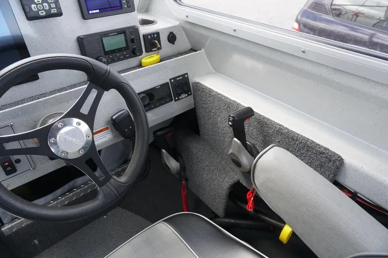 Slide: The Image of Interior of 2023 Weldcraft Ocean King 220 boat with steering wheel and control panel. - 39