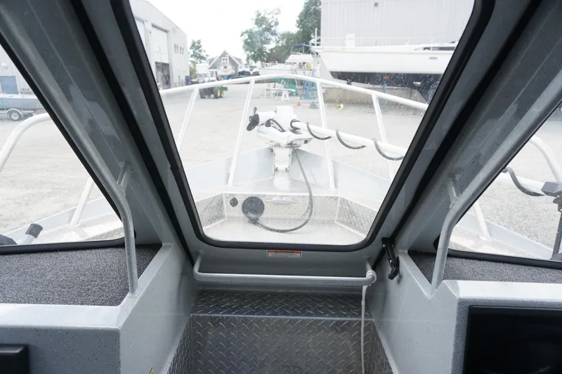 Slide: The Image of Interior view of 2023 Weldcraft Ocean King 220 boat, showcasing helm and windshield. - 41