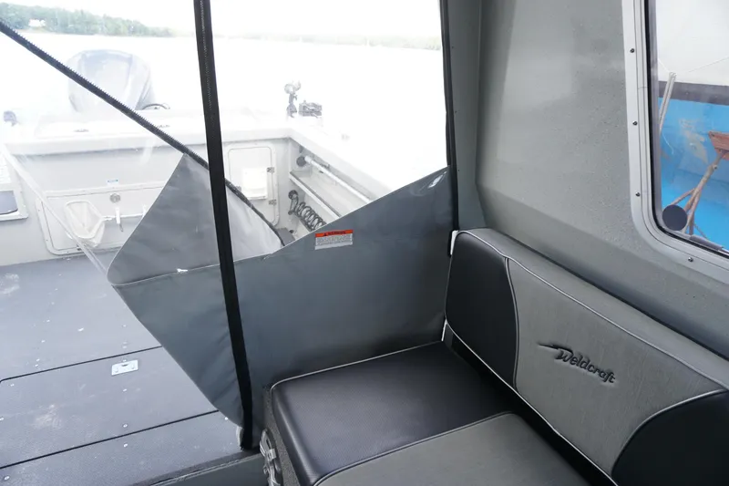 Slide: The Image of Interior view of 2023 Weldcraft Ocean King 220 boat, featuring seating and deck area. - 44
