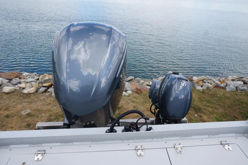 Slide: The Image of 2023 Weldcraft Ocean King 220 boat engines by a rocky shoreline. - 50