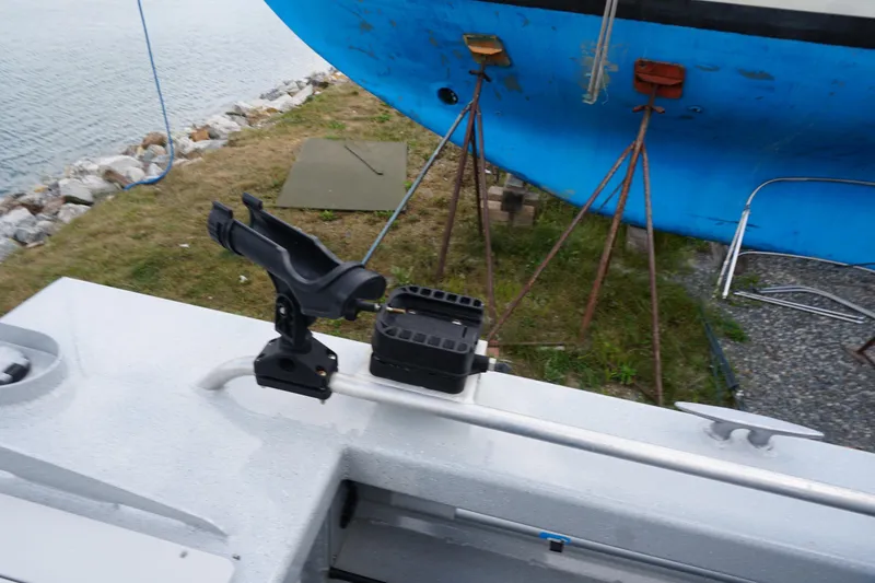 Slide: The Image of 2023 Weldcraft Ocean King 220 boat detail with rod holder, docked near water. - 51