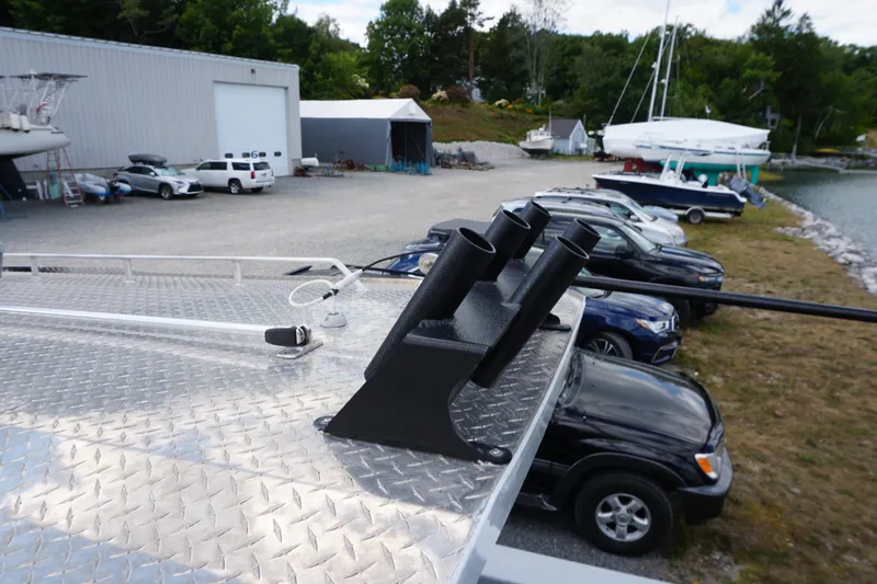 Slide: The Image of Rooftop view of 2023 Weldcraft Ocean King 220 with rod holders, parked near a marina. - 53