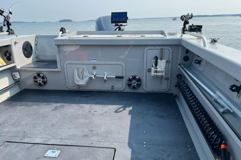 Slide: The Image of 2023 Ocean King 220 boat interior with fishing equipment and open water view. - 6