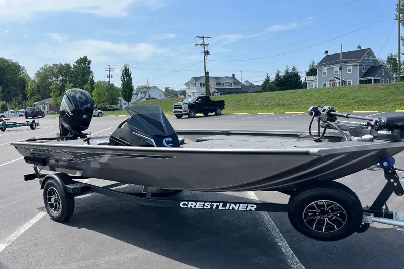 Slide: The Image of 2026 Crestliner XFC 179 boat on trailer in parking lot, sunny day. - 2