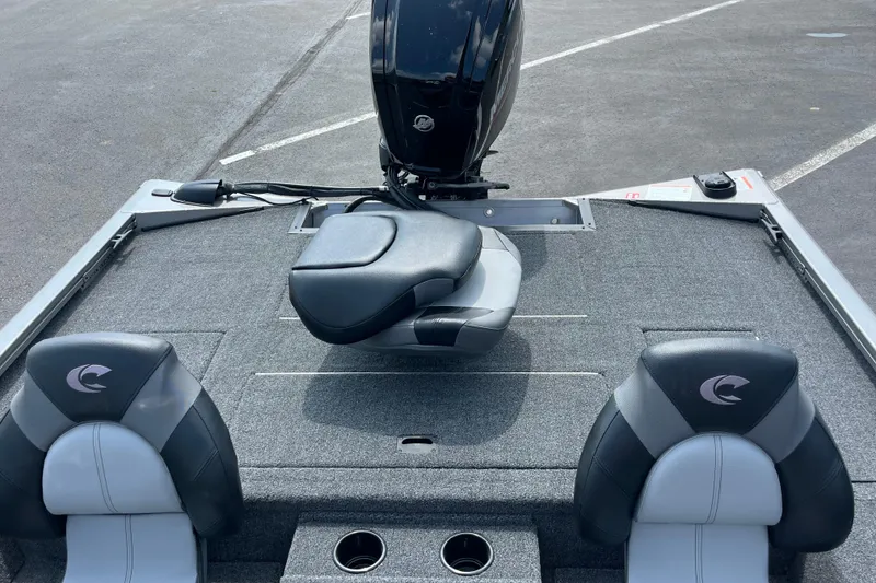 Slide: The Image of 2026 Crestliner XFC 179 boat interior with seating and motor, parked on asphalt. - 3