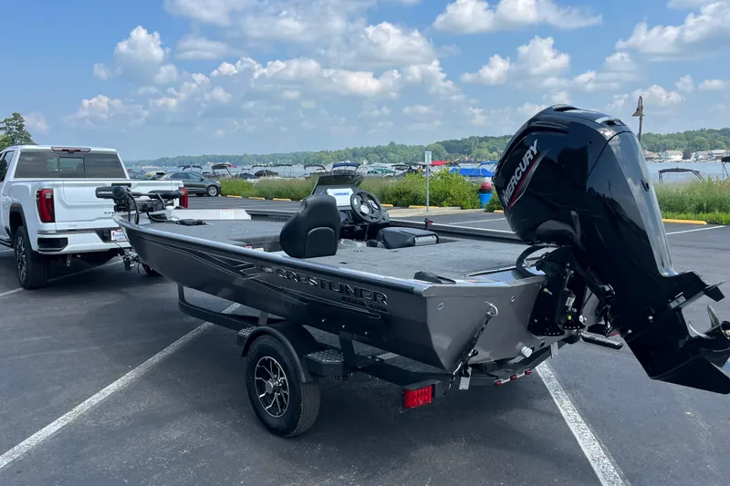 Slide: The Image of 2026 Crestliner XFC 179 boat on trailer, parked near a lake under a cloudy sky. - 8