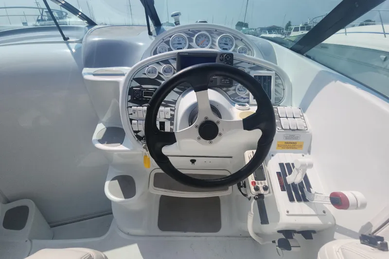 Slide: The Image of 1999 Baja 38 Special boat cockpit with steering wheel and control panel. - 2