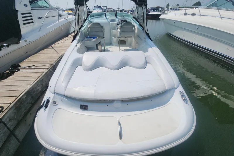 Slide: The Image of 1999 Baja 38 Special boat docked, featuring sleek white seating and modern design. - 4