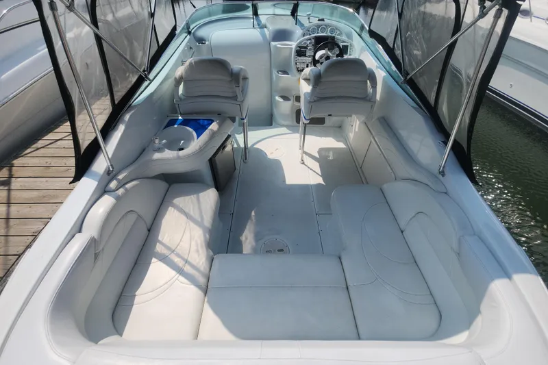 Slide: The Image of 1999 Baja 38 Special boat interior with white seating and steering console. - 5