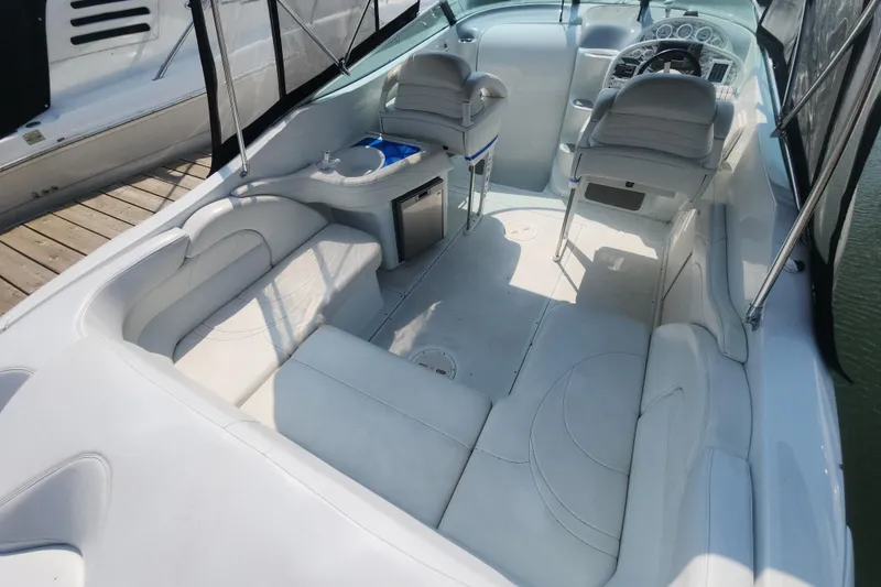 Slide: The Image of 1999 Baja 38 Special boat interior with white seating and modern dashboard. - 6